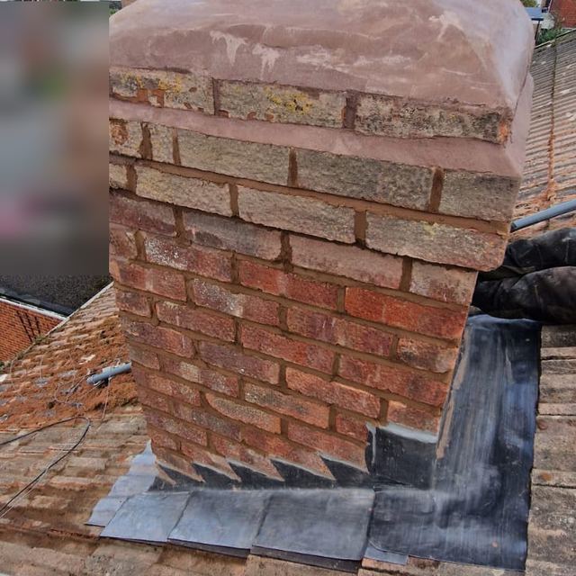 Repointed chimney with new lead flashing and a cowl