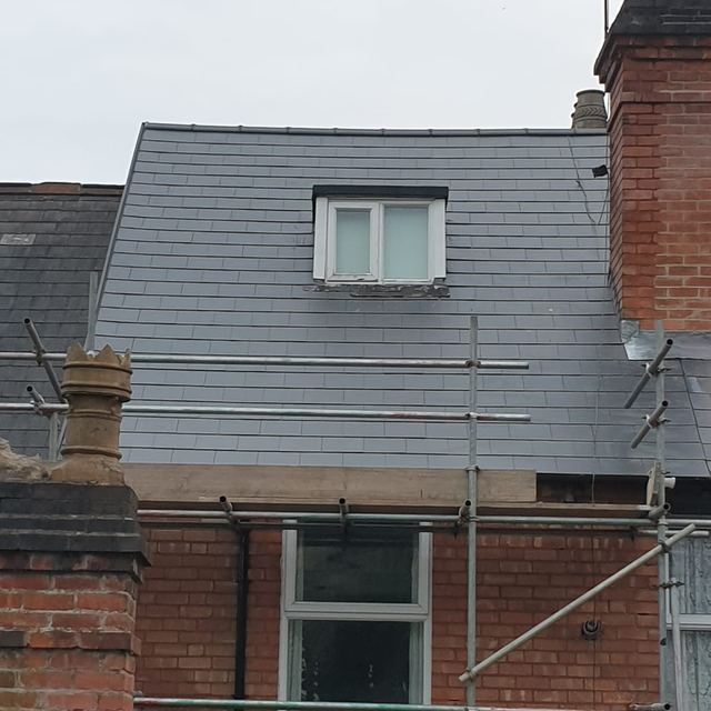 New slate roof with a dormer on a terraced house