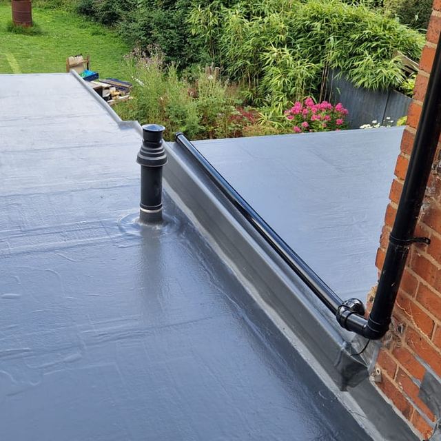 Finished flat roof with a vent pipe and new drainage