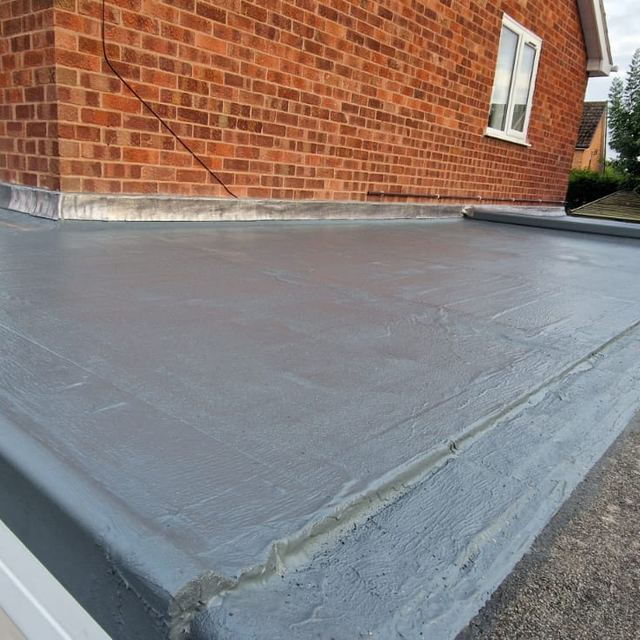 Grey fibreglass flat roof over a garage