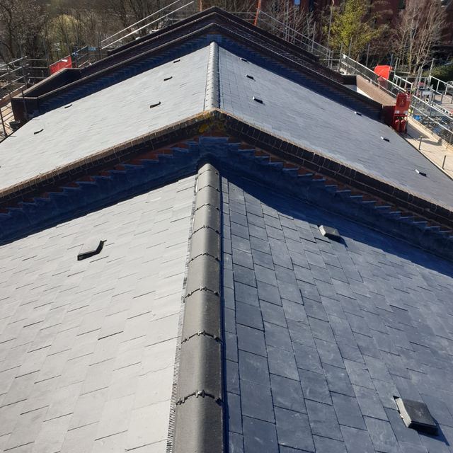New slate roof with a dry-fixed ridge on a large house