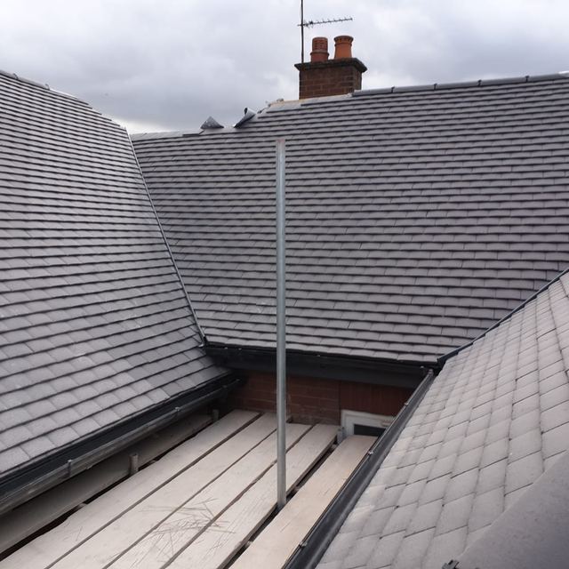 New grey tiled roof with hips and valleys