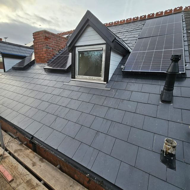 New slate roof with a dormer window and solar panels