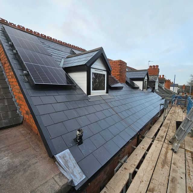 New slate roof with dormers and solar panels on a terrace