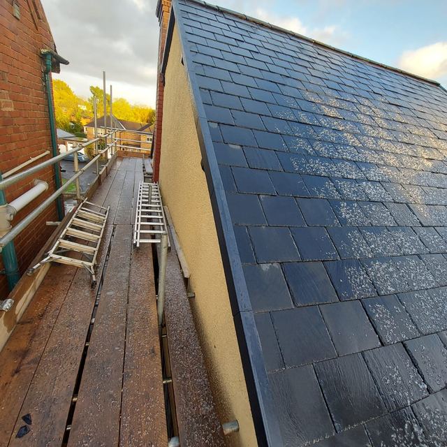 New slate roof on a side wall, seen from the scaffold