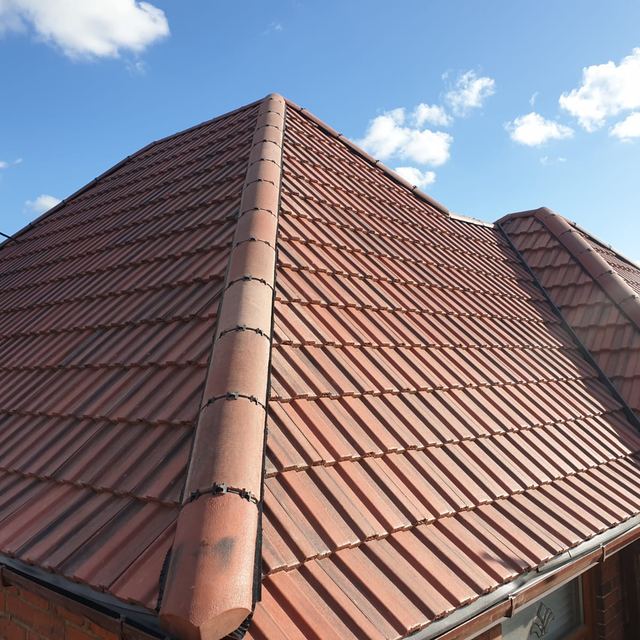 New hipped roof in red interlocking tiles