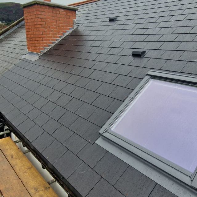 Roof window in a new slate roof