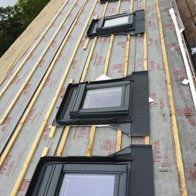 Row of new roof windows fitted during a re-roof